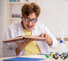 Wall Mural - Funny crazy chemist doing experiments and tests