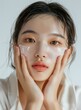 © Adobe Contributor - Beautiful Asian Woman Applying Face Cream