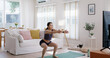© ChayTee - Young adult asia people girl fun squat weight loss on TV online gym class at home. Active self love good shape woman enjoy diet course wear smart watch health IOT fitness tracker internet of things.
