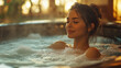 © Mangsaab - Beautiful young woman relaxing in hot tub with closed eyes and smiling. Wellbeing spa concept.