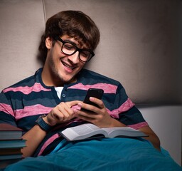 Canvas Print - Young student preparing for exams at night at home