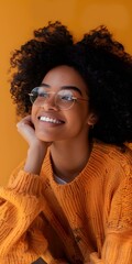 Wall Mural - Young Woman with Curly Hair Smiling in Orange Sweater