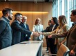 © Molang Visual - Business People Shaking Hands in a Meeting Room