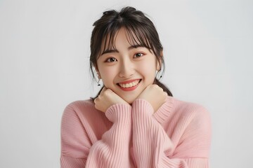 Canvas Print - Portrait of a Young Asian Woman Smiling with a Pink Sweater