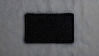 blank black rectangle embroidered patch mockup on white table, top view