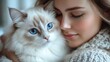 © KADER - Close-Up of Woman Cuddling White Fluffy Cat with Blue Eyes - Cozy and Warm Indoor Scene