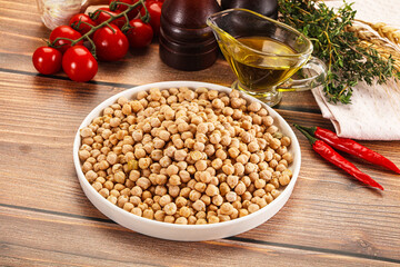 Wall Mural - Dry chickpea seeds heap in the bowl