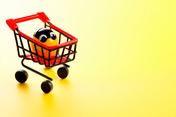 Mini Shopping Cart with Smiley Face on Yellow Background, black friday