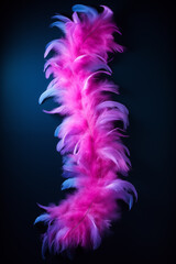 Poster - Pink and blue feathers forming a column on black background