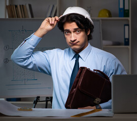 Wall Mural - Young male architect working night at office