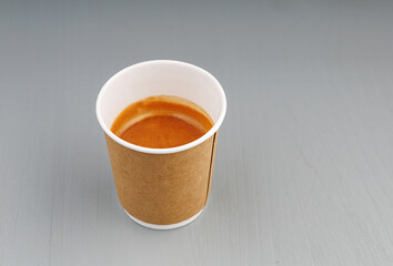 top view cardboard cup with coffee, espresso, americano on gray wooden background