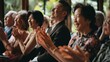 © VK Studio - A joyful group of people clapping and smiling during an indoor event, exuding happiness and camaraderie.