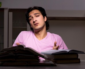 Poster - Male handsome student preparing for exams late at home