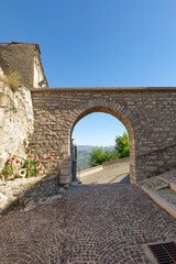 Poster - A street between old houses in Pietrabbondante, a village in Molise in Italy.