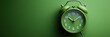 © Olga - Green alarm clock on a green background, flat lay, top view, copy space concept. Wallpaper, background, banner