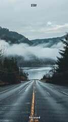 Wall Mural - A road with a foggy mountain in the background