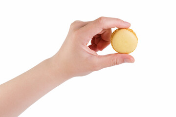 young female hand holding yellow macaron isolated on white