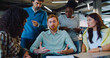 © ihorvsn - Camera focus on handsome Caucasian man with red hair and moustache. Male trying to explain something to work colleagues. People not agreeing. Difficulty in communication. Negative feedback.