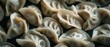 © Thanapipat - A close-up view of delicious, handcrafted dumplings showcasing intricate pleats and a soft texture, perfect for culinary presentations.