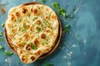 © Maryam - Indian bread above view on blue table. Homemade naan bread