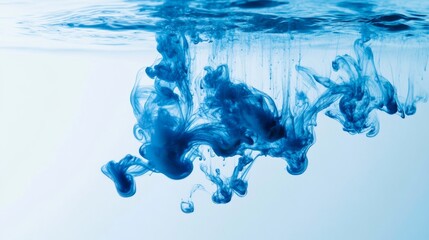 Leinwandbilder - Blue ink dropping into clear water, creating swirling patterns and abstract shapes