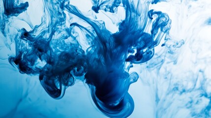 Leinwandbilder - Blue ink dropping into clear water, creating swirling patterns and abstract shapes