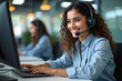 © Amir Bajric - Smiling happy Indian call center agent wearing headset talking to client, contract service telemarketing operator using laptop having conversation working in customer tech assistance support office.