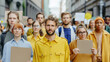 © Coco.Ratta - Caucasian young man leads for protests that bring people protesting with blank cardboard sign and laborer to the street