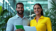 © fotogurme - Two business people smiling while reviewing a document in a modern office sunlit space sleek glass walls and minimalistic decor business casual attire bright natural lighting positive vibe