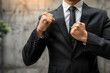© Ekaterina - A business professional in a suit stands with a fist on their chest, symbolizing confidence, determination, and success in business
