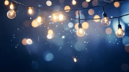 Wall Mural - glowing christmas lights with bokeh effect on blue background. christmas golden light shine particle