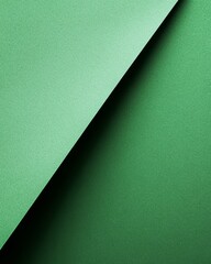 Wall Mural - Green paper texture with diagonal folds showcasing depth and shade variations in natural light