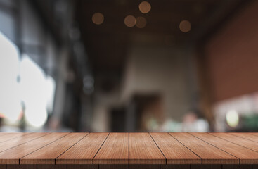 Wall Mural - Empty wooden table top with lights bokeh on blur restaurant background.