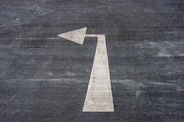 Left turn only arrow painted on an asphalt road