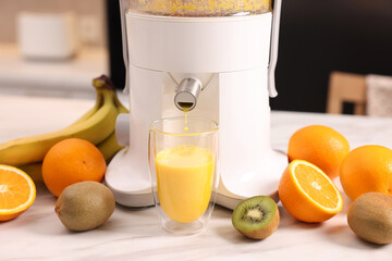 Canvas Print - Modern juicer, fresh fruits and glass on white marble table in kitchen, closeup