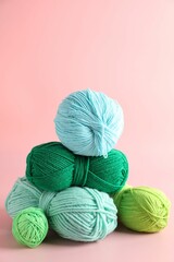 Wall Mural - Pile of different colorful yarns on pink background