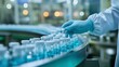 © kinara art design - A gloved hand inspects bottles of liquid on a conveyor belt in a pharmaceutical factory.
