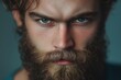 © StockUp - A man with a rugged thick beard and piercing eyes stares forward intensely, embodying strength and determination.