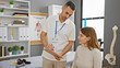 © Krakenimages.com - A male physiotherapist with a clipboard consults a female patient in a medical rehab clinic.