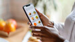 © Sunday Cat Studio - A person using a smartphone to browse food options, showcasing modern technology in everyday life.