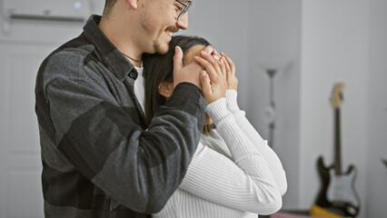 Wall Mural - A man surprises woman with eyes covered in a cozy living room, expressing love and affection.