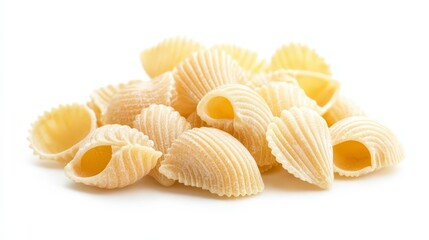 A close-up of a pile of raw conchiglie pasta isolated on a white background.