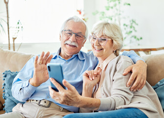 Wall Mural - woman man senior couple phone online communication senior call video elderly mobile smartphone communication active video conference retirement together