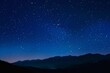 © Babb - A starry night sky with mountains in the background