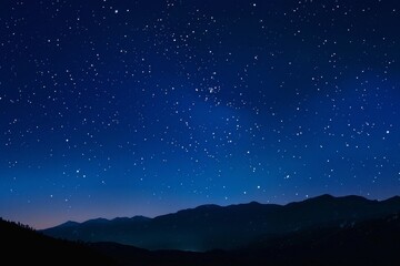 Wall Mural - a starry night sky with mountains in the background