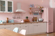 © New Africa - Pink refrigerator in furnished kitchen. Stylish interior