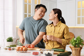 Wall Mural - Happy lovely couple cooking together in kitchen