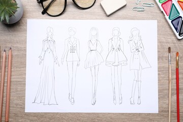 Poster - Sketch of stylish clothes and other fashion designer`s supplies on wooden table, flat lay