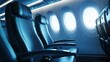 © Business Image - Row of empty airplane seats with light shining through porthole windows, highlighting the serene and tranquil atmosphere inside the cabin.