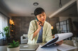 © Miljan Živković - Japanese woman with work from home on laptop and talk on mobile phone